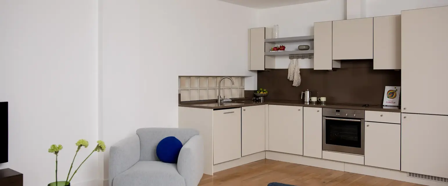 a living room with a couch and kitchen