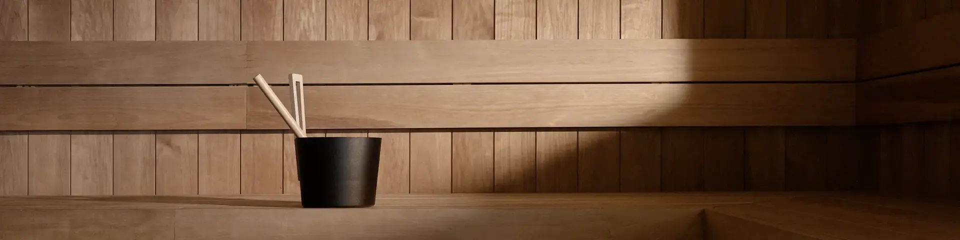 a wooden bench with a cup of chopsticks in it