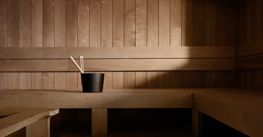 a wooden bench with a cup of chopsticks in it