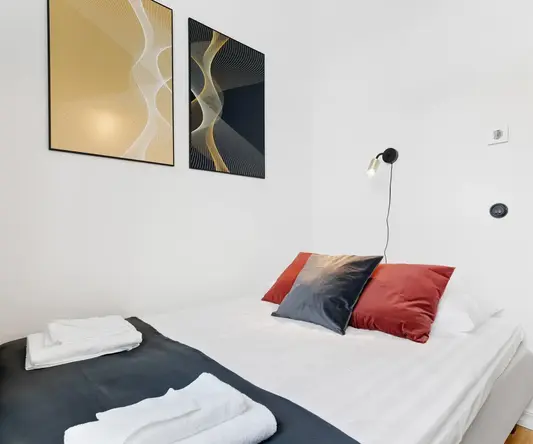 a bed with pillows and towels on it