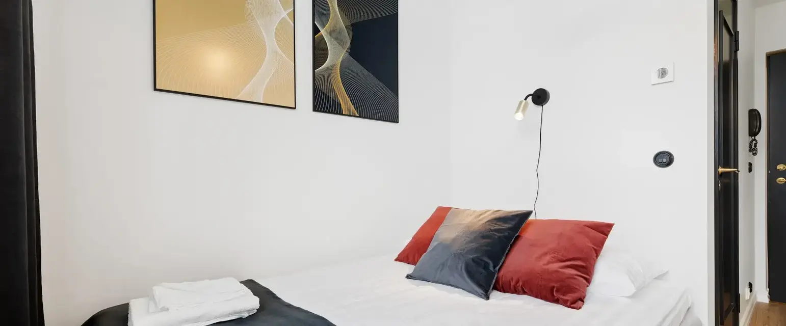 a bed with pillows and towels on it