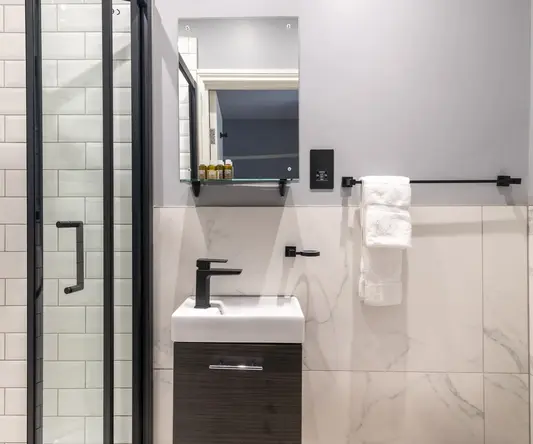 a bathroom with a mirror and sink