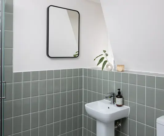 a bathroom with a mirror and a sink