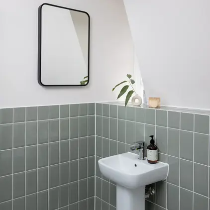 a bathroom with a mirror and a sink