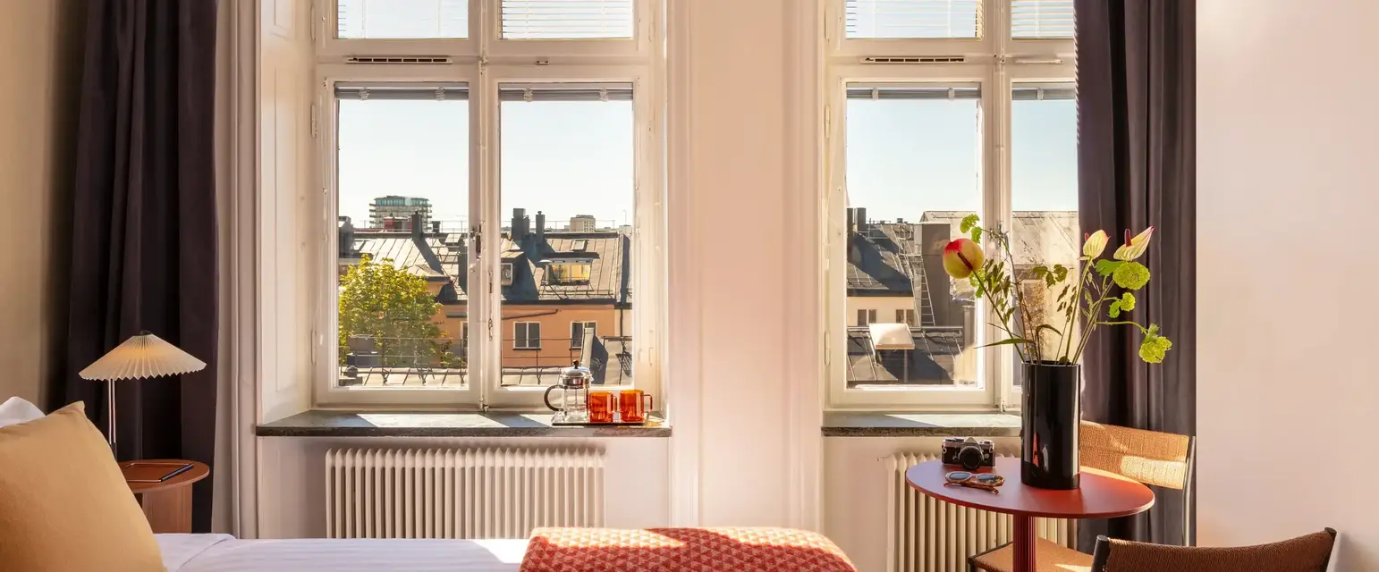a room with a bed and windows