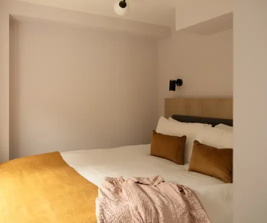 a bed with pillows and a blanket