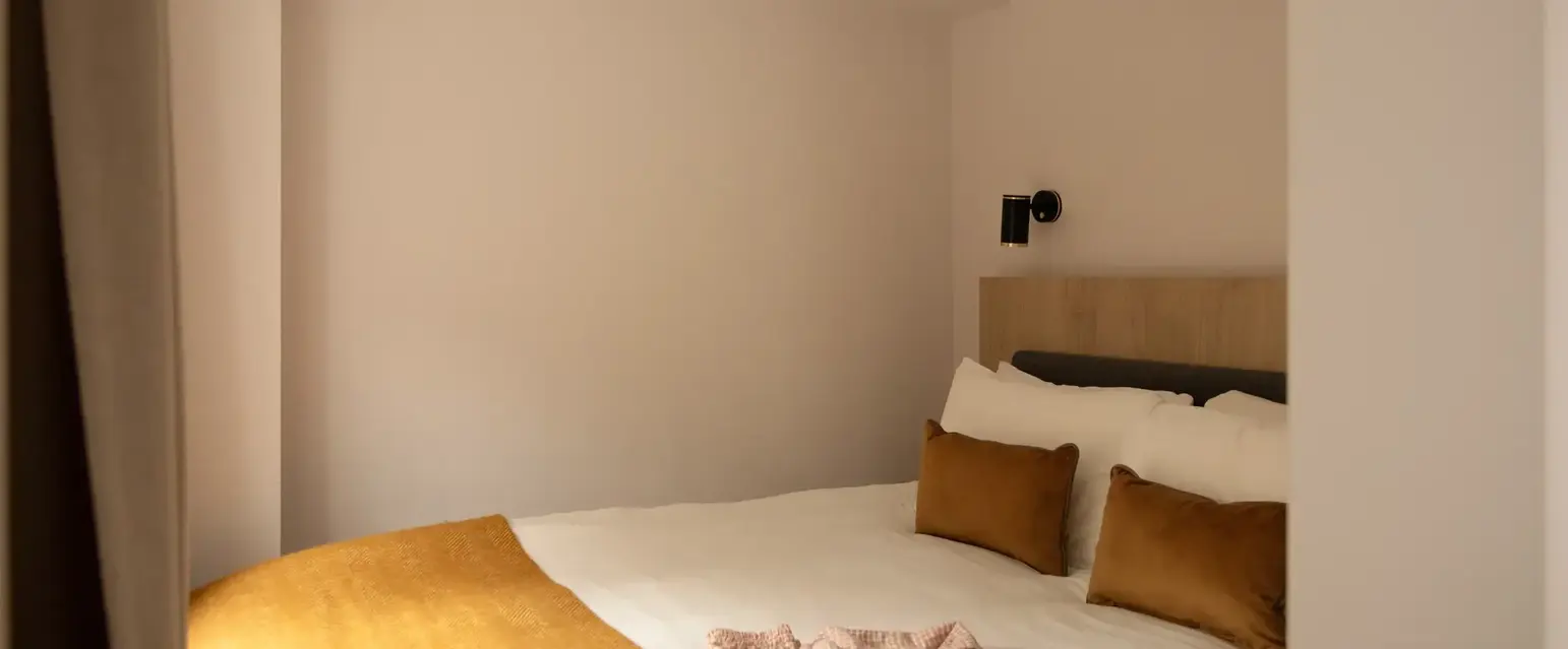 a bed with pillows and a blanket