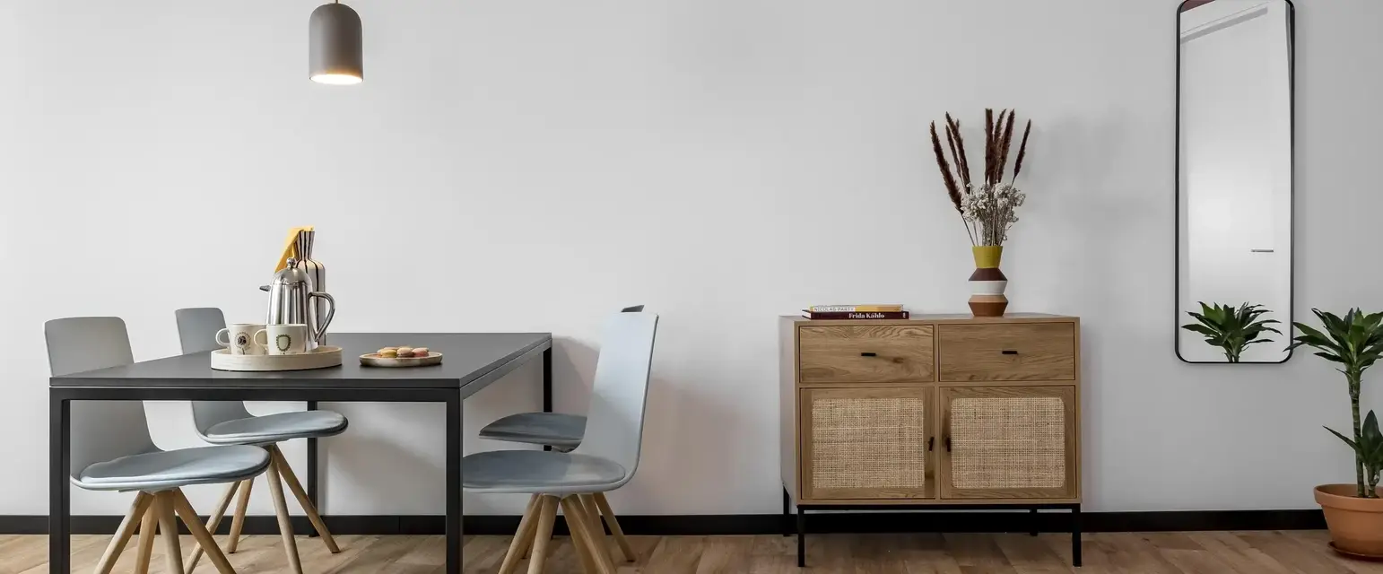 a dining table and chairs in a room