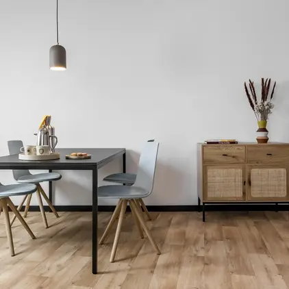 a dining table and chairs in a room
