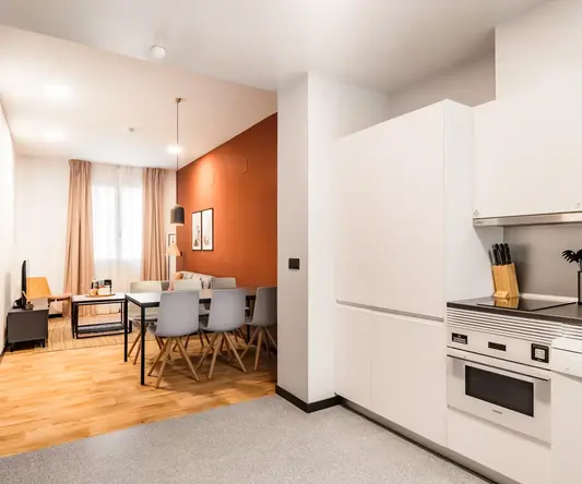 a kitchen with a dining table and chairs