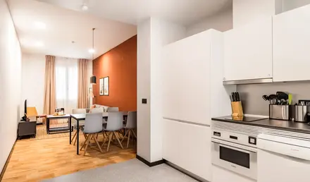 a kitchen with a dining table and chairs