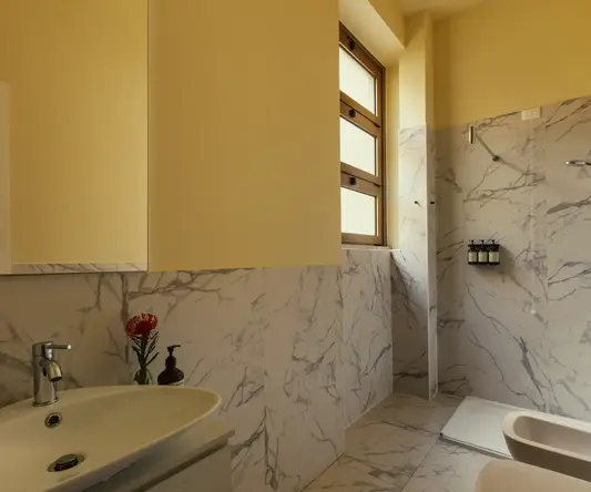 a bathroom with marble walls and a sink