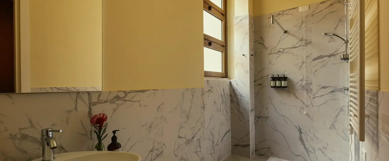 a bathroom with marble walls and a sink