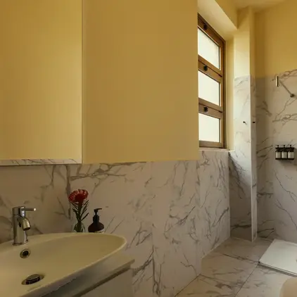 a bathroom with marble walls and a sink