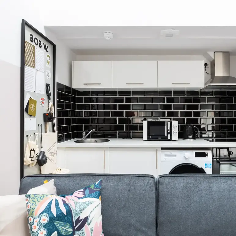 a kitchen with a couch and a microwave