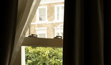 a window with a view of a street and trees