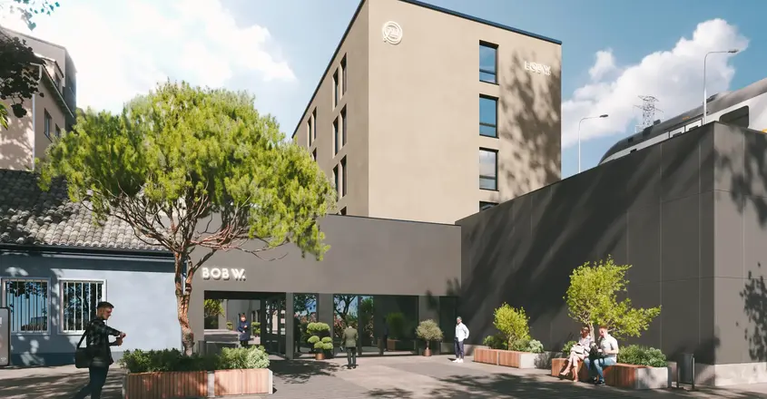 a building with trees and people in front of it