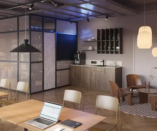 a room with a laptop and chairs