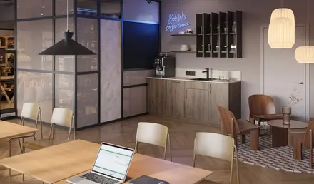 a room with a laptop and chairs