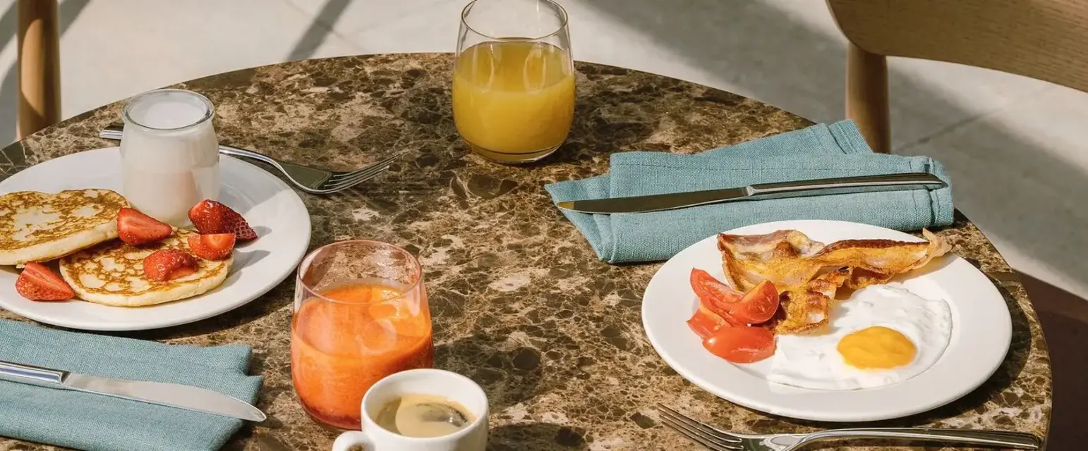a table with plates of food and drinks