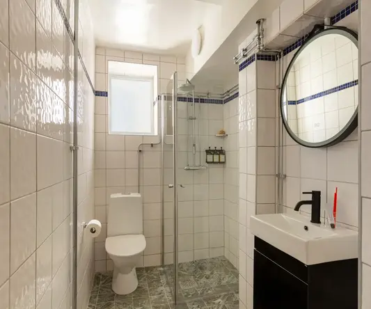 a bathroom with a mirror and a toilet