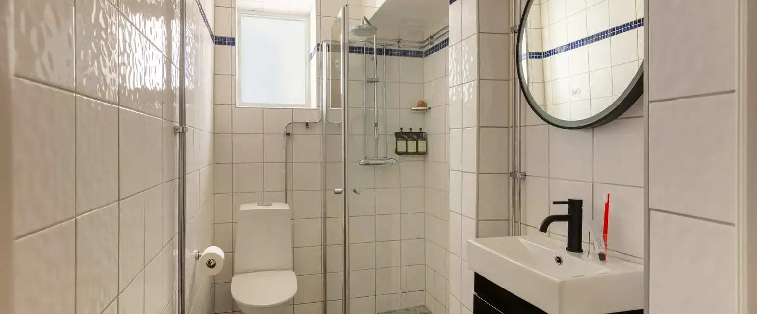a bathroom with a mirror and a toilet