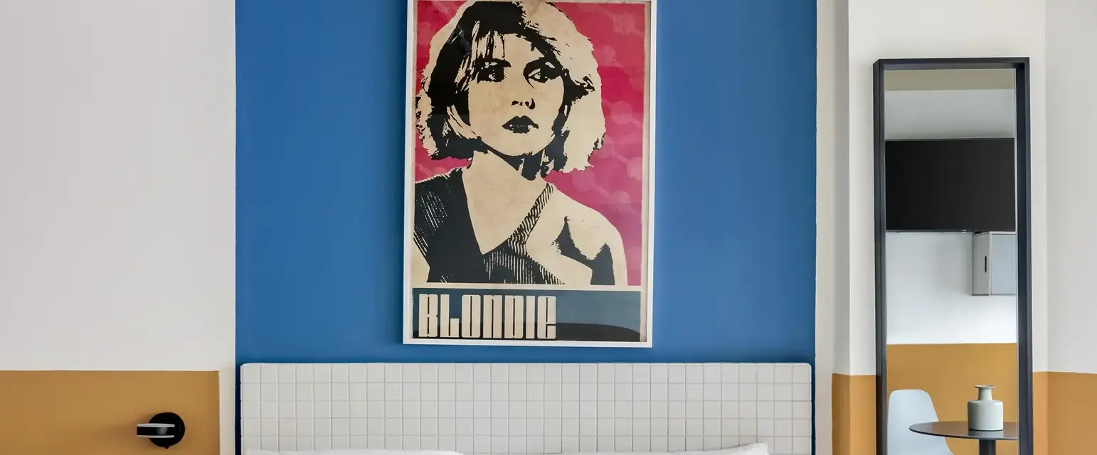a bed with a poster on the wall