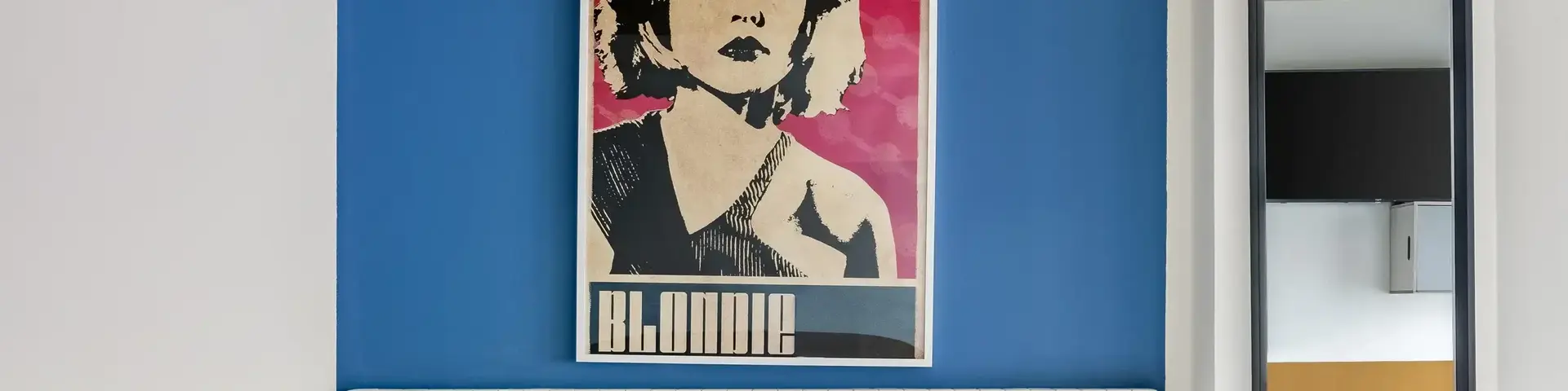 a bed with a poster on the wall