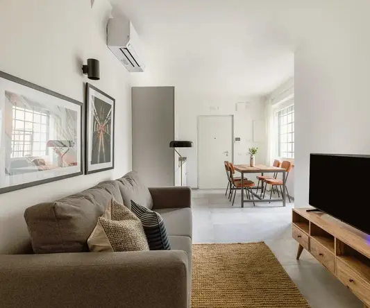 a living room with a couch and a table and chairs