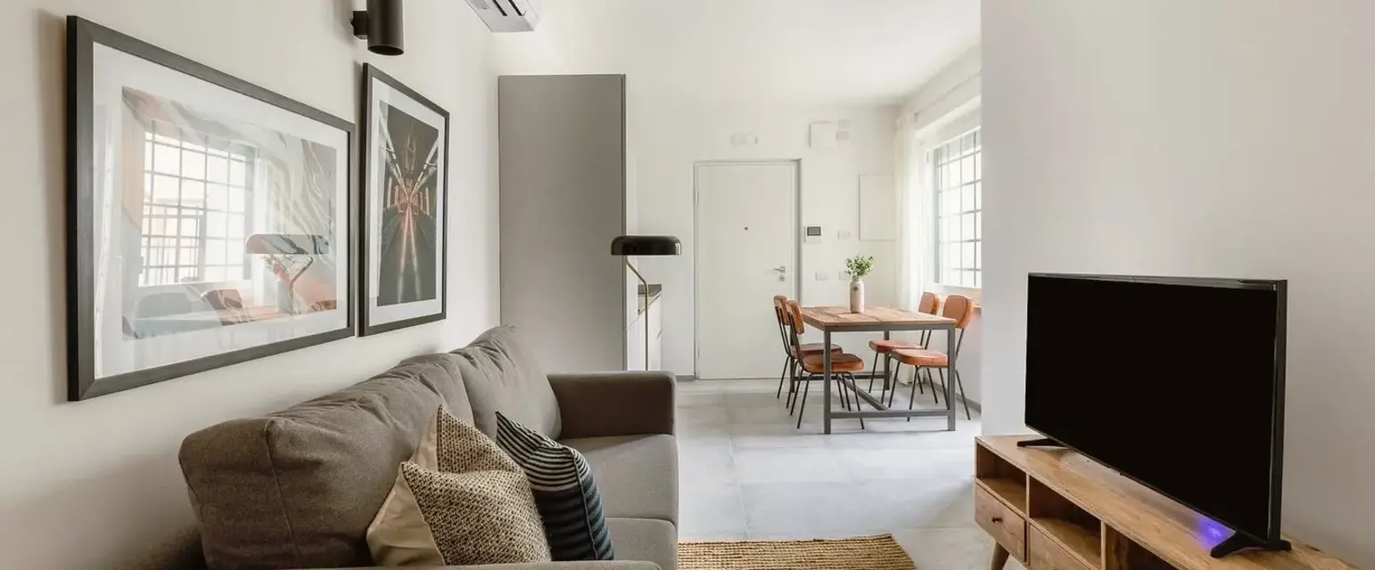 a living room with a couch and a table and chairs