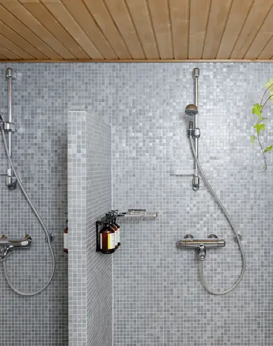 a shower with many shower heads and hoses
