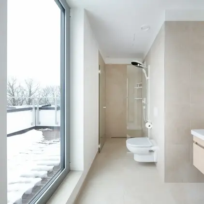 a bathroom with a large glass door
