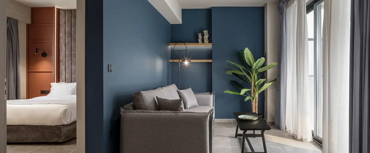 a living room with a couch and a plant