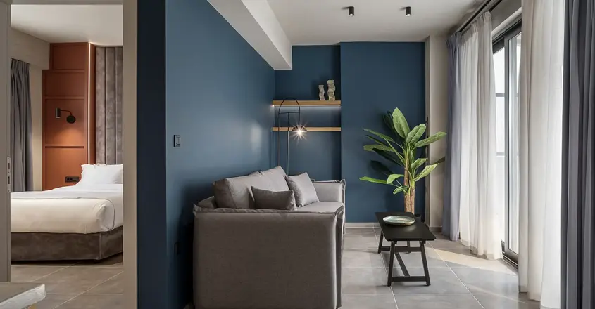 a living room with a couch and a plant