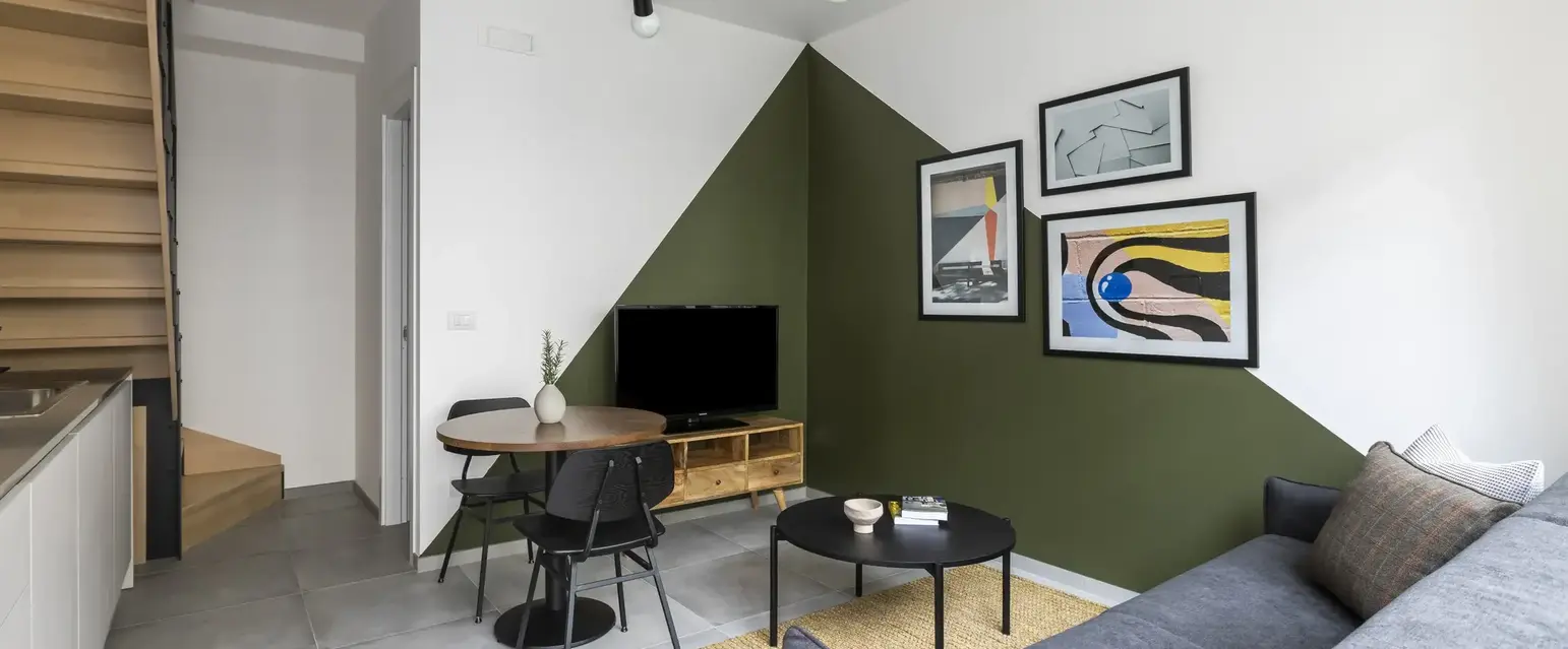 a living room with a table and chairs