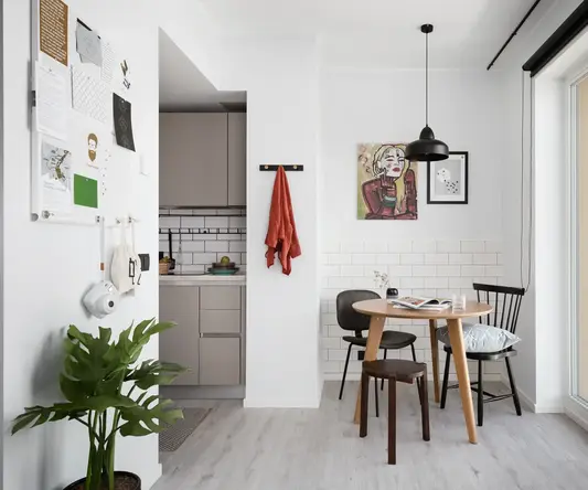 a dining room with a table and chairs