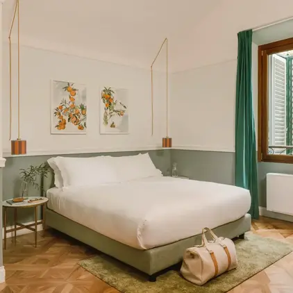 a bedroom with a bed and a bag