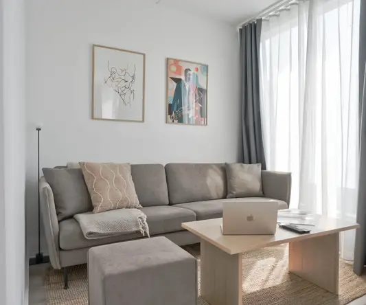 a couch with a laptop on a table in a room