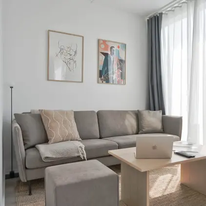 a couch with a laptop on a table in a room