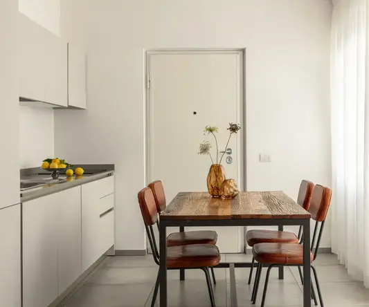 a dining table with chairs in a kitchen