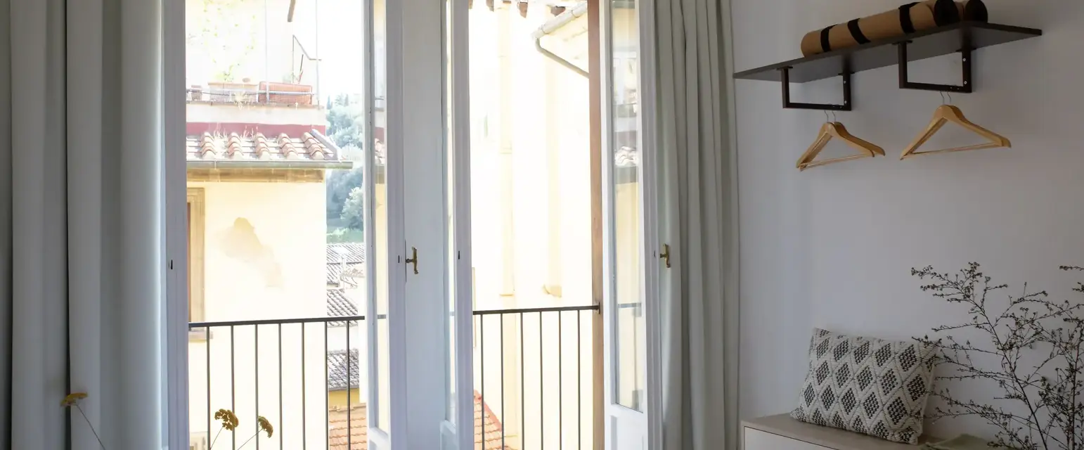 a bedroom with a bed and a bench and a door