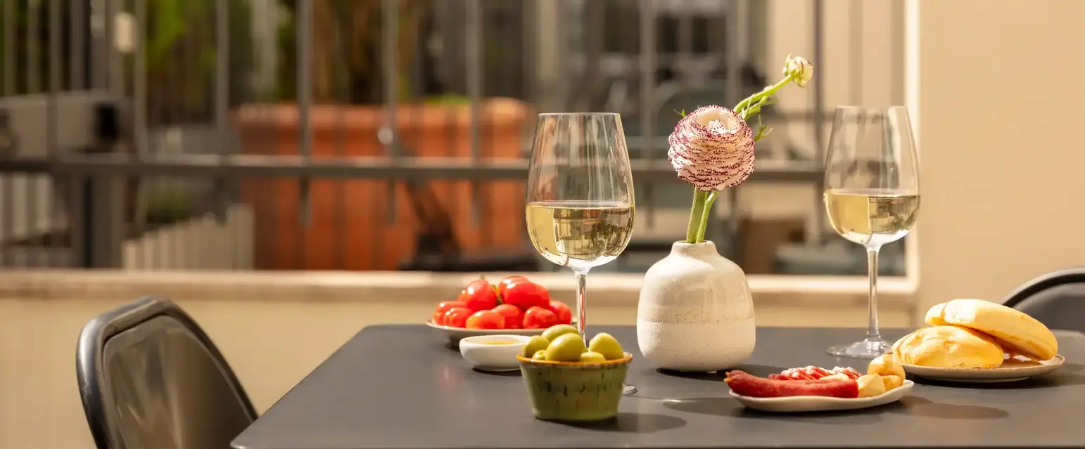 a table with food and wine glasses on it