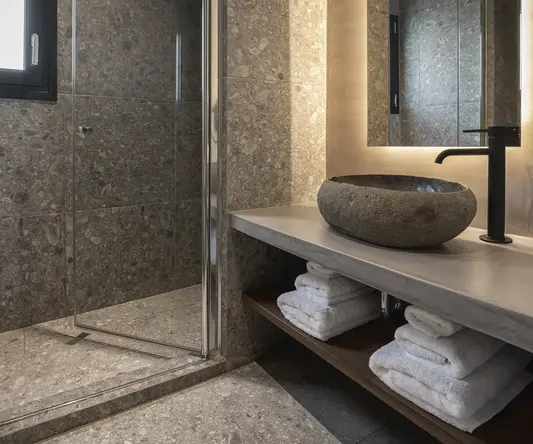 a bathroom with a glass shower and sink