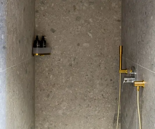 a shower with a shower head and a shower head