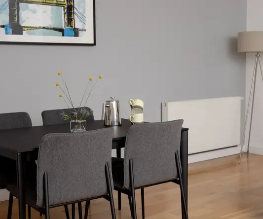 a dining table and chairs in a room