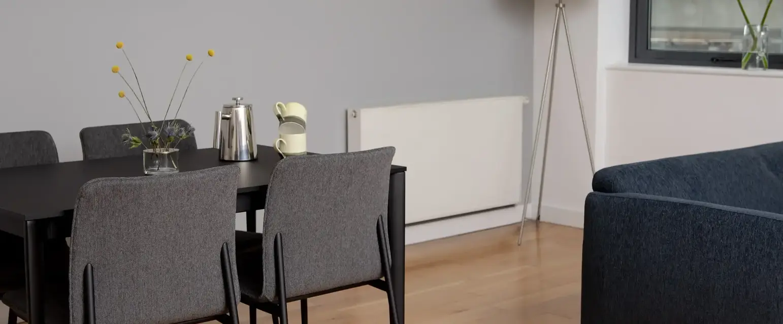 a dining table and chairs in a room