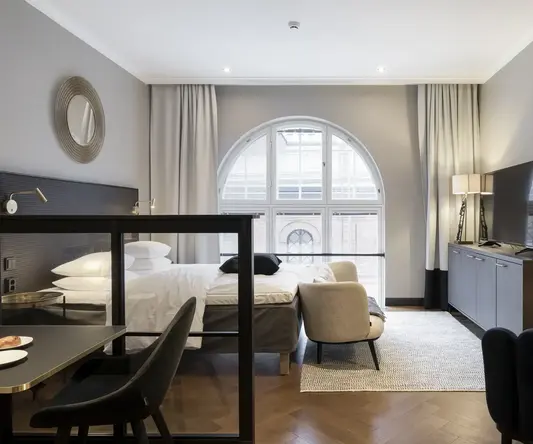 a room with a bed and a tv