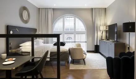 a room with a bed and a tv