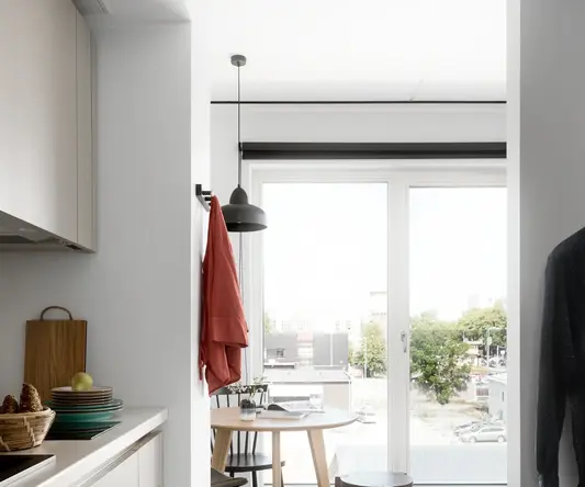 a kitchen with a table and chairs