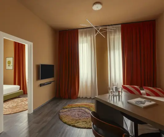 a room with a table and chairs and a tv